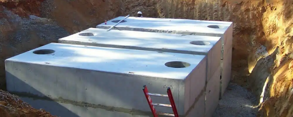 Septic tank installation site with a newly placed concrete tank in Fresno, CA